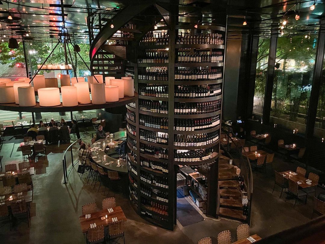 Purple Cafe’s central wine tower and staircase are the centerpiece of the room. Credit: @purplecafeseattle