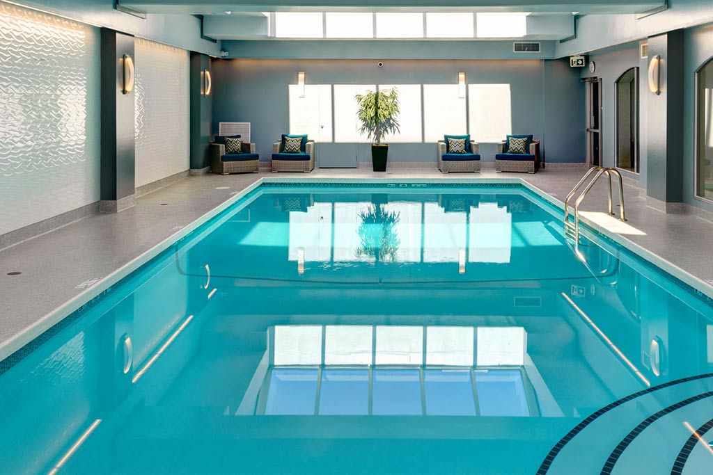 Beat the summer heat with a relaxing dip in the pool on your family vacation. Credit: Chateau Victoria Hotel & Suites