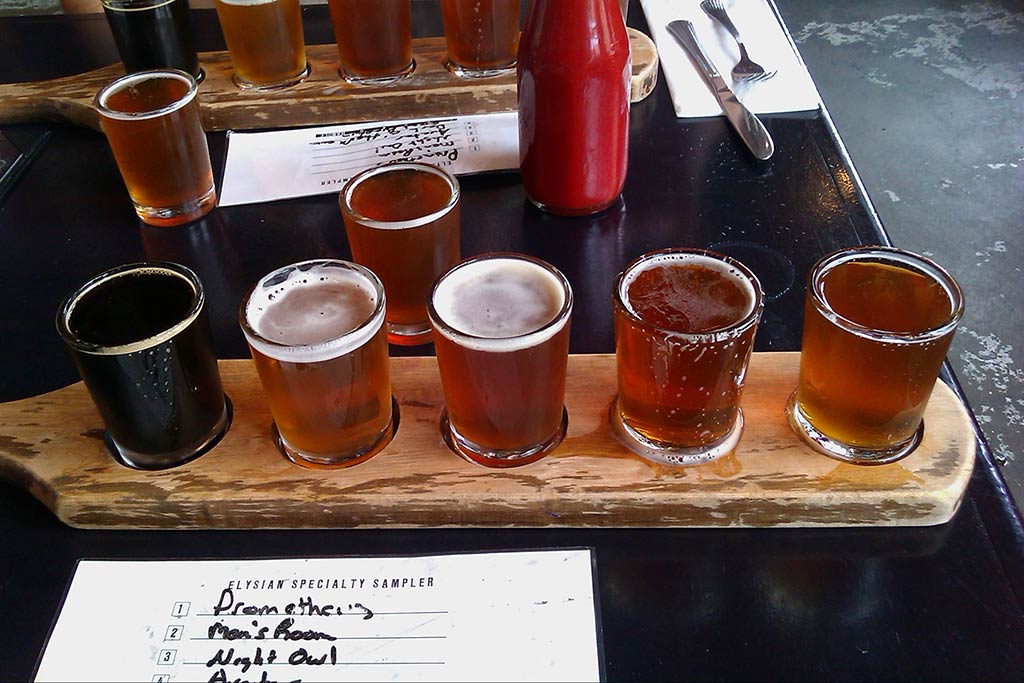 Five fine IPA’s at Elyisan Brewing, including local favorite Night Owl 3rd from right and seasonal Pumpkin Porter left on tray. Credit: Flickr/hollyking