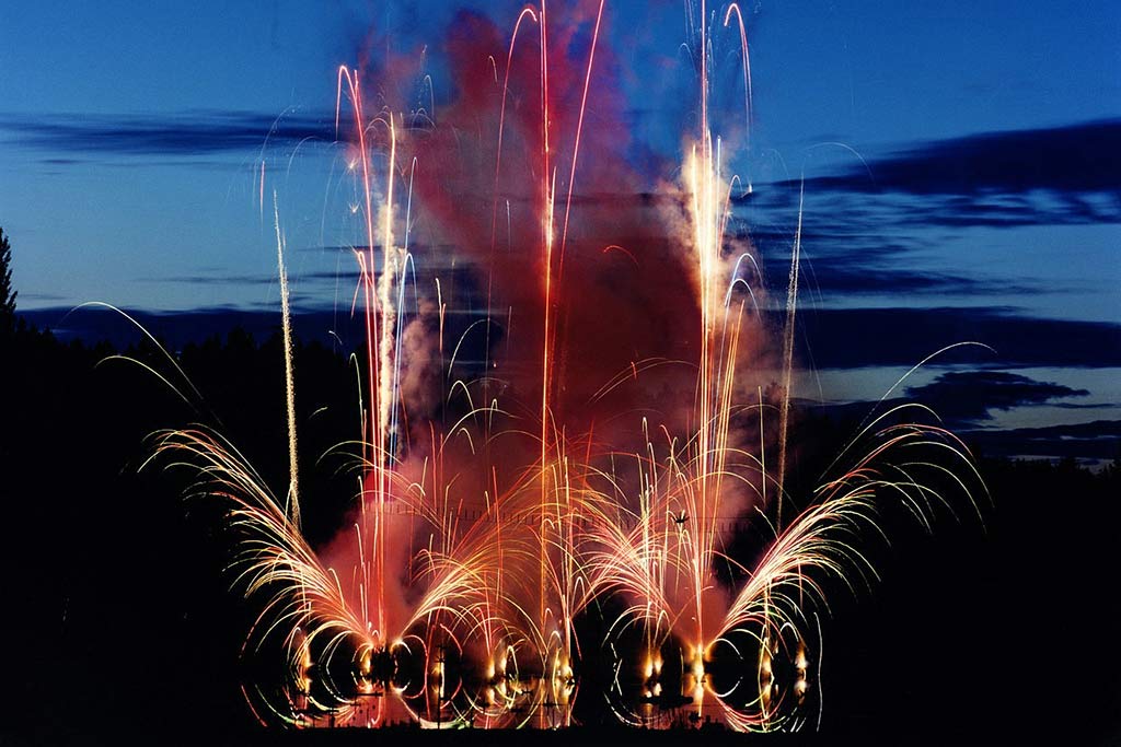 Vibrant fireworks displays soar high above The Gardens, lighting up the grounds. Credit: the Butchart Gardens
